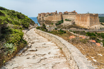 Fototapeta premium The city of Bonifacio perched on its scenographic cliffs on a sunny summer day. Southern Corse, France.