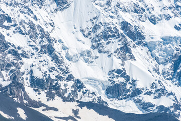 Snow sliding down the steep slope of Mount Shkhara