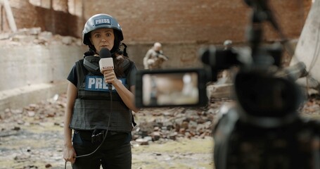 POV Camera view, female war journalist correspondent wearing bulletproof vest and helmet reporting...