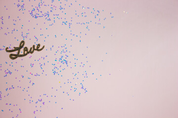 Love letter with glitter over the pink background. 