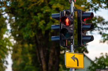 traffic semaphore with red pedestrian light on defocused urban background, closeup
