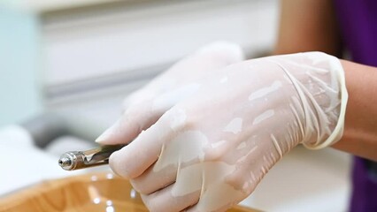 A close-up scene of dentist assistant in medical gloves preparing an injection with anesthesia before surgery. Medicine and health concept. Unrecognizable person.