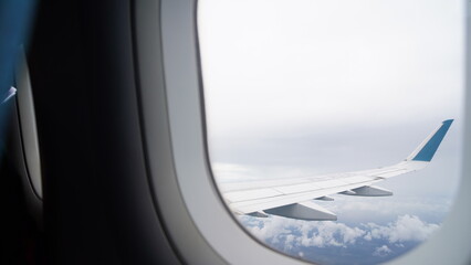 Fototapeta na wymiar Plane window view, clouds, plane wing, aesthetic