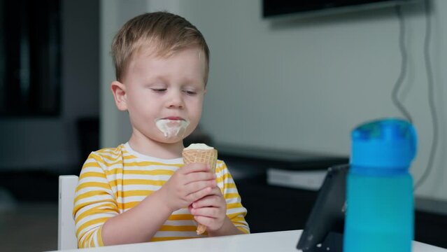 Kid Watching Cartoons On Tablet. Grimy, Eats Ice Cream