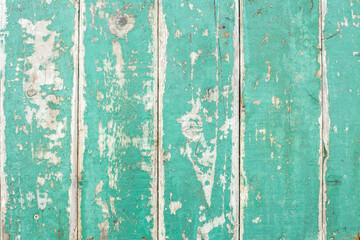 Texture, wood with old green paint, can be used as a background. Wood texture with scratches and cracks.