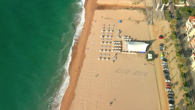 Aerial image with drone of Calella in the Maresme flights over the beach without people on a beach bar in the front line