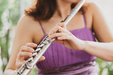 Flute :  A closeup of hands of a musician playing the flute, detail shot, classical music, wind...