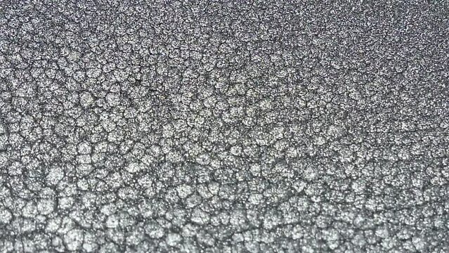 Mottled silver metallic ink wallpaper. Abstract texture background.
