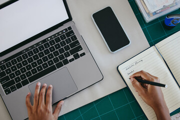 Top view of hands, laptop or notebook writing for creative brand logo, digital marketing strategy...