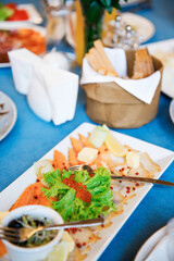 Fish plate on the banquet table, salmon, shrimp, sauce