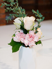 A stylish vase with flowers on the table.