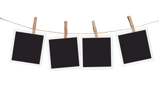 Four blank instant photo frames hanging on a rope, isolated on transparent  background
