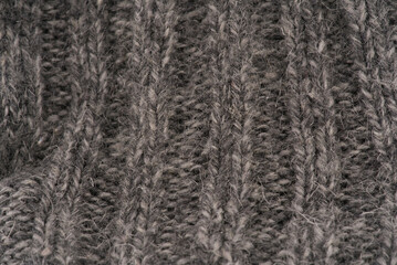 The texture of the wool closeup. Dark gray color. Vertical lines