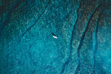 Topdown of a Surfer in the middle of the ocean