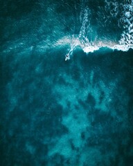 Topdown of a Surfer in the middle of the ocean