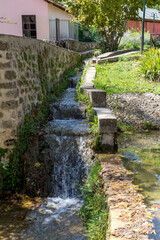 Small canal in Edessa city park (Central Macedonia, Greece) with fast flowing water