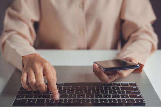 Woman hand enter a one time password for the validation process on laptop, Mobile OTP secure Verification Method, 2-Step authentication web page, Concept cyber security safe data protection business.