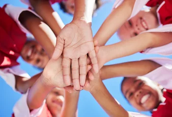 Fotobehang Team, children and soccer athlete hands together to show sport community, support and success. Fitness, football and exercise training proud hand sign of friends and players ready for teamwork © Nina Lawrenson/peopleimages.com