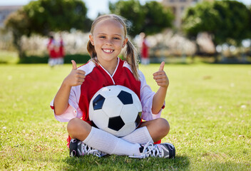 Ball, soccer and girl thumbs up on field, training and sports activity outdoor. Portrait of young...