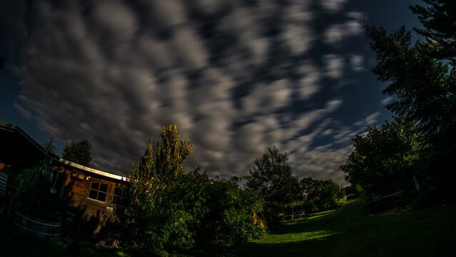 time lapse of starry sky at full moon with clouds