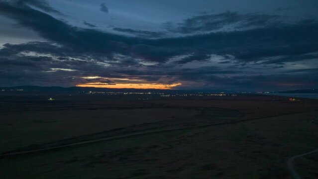 Hyperlapse shot over river and rural area with countryside fields at sunset time in Romania