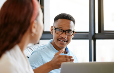 Obraz premium Black man, designer and creative discussion with staff for ideas, strategy and planning in marketing agency startup. Young african guy talking, speaking and explain colleague, employees and teamwork