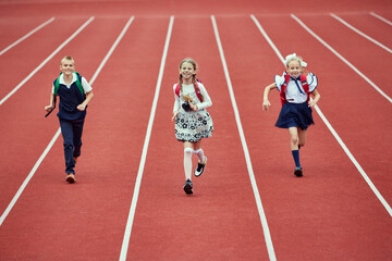 Start. Back to school, kids and education concept. Girls and boy dressed in school uniform as...