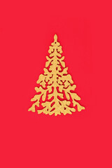 Festive gold glitter ornate Christmas tree on red background, Minimal traditional design for Xmas and New Year holiday season.