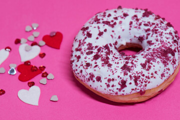 Macro shoot of white chocolate donut over pink