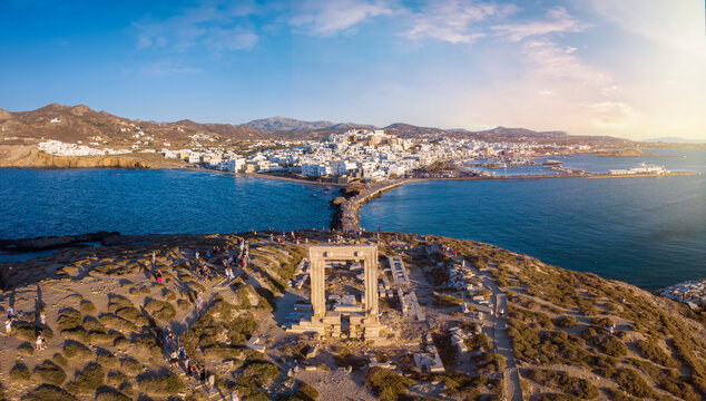 Aerial view of the famous Portara Gate at Naxos island, Cyclades, Greece, with the town behind during summer sunset time