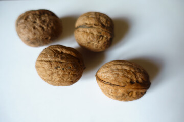 4 ripe brown rounded wrinkly fruits of Persian walnut