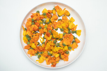 Medicine calendula flowers on white plate