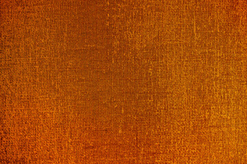 Golden wall with abstract spots as a background. Beautiful golden texture with patterns, decorative plaster. Modern bright wall painting in trendy shades, unusual spotted yellow and gold surface.