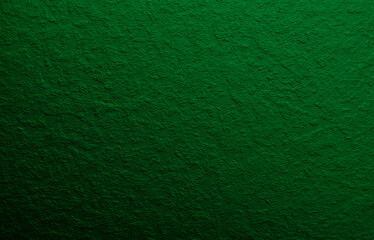 Green background from decorative plaster with abstract spots. Unusual green wall texture with beautiful patterns, creative surface background. Front covering for facing of buildings.