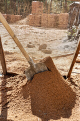 Sifting sand for mortar at the construction site. Purification of sand from impurities for the...