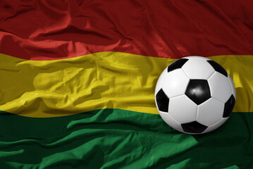 vintage football ball on the waveing national flag of bolivia background. 3D illustration
