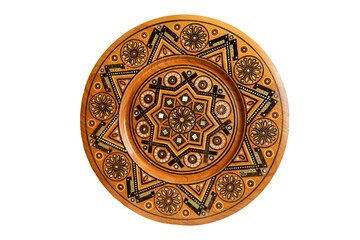 Isolated on white wooden souvenir plate with carved and decorated ornament