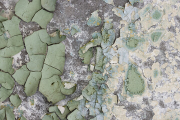 Peeling paint on the wall. Old concrete wall with cracked flaking paint. Weathered rough painted...