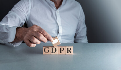 man posing wooden block g d p r or general data protection regulation . concept of internet security .