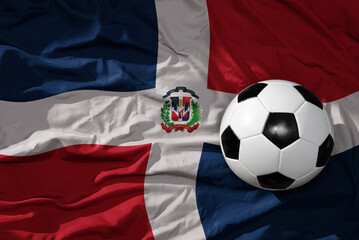 vintage football ball on the waveing national flag of dominican republic background. 3D illustration