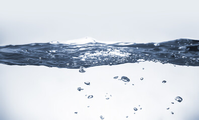 Water splash Aqua flowing in waves and creating bubbles Drops on the water surface feel fresh and clean isolated on white background.