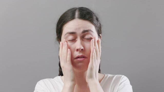 Portrait of a young woman rubbing her eyes. Eye irritation and ophthalmology. Eye microsurgery and myopia.
