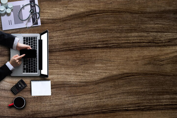Top view of doctor desk table with stethoscope, coffee, Medical gown and notebook.
