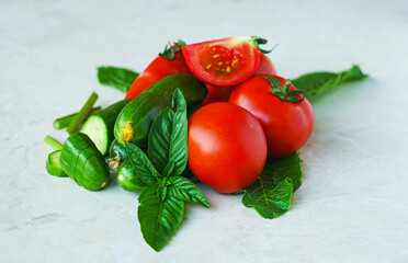 Tomatoes and cucumbers on a white background