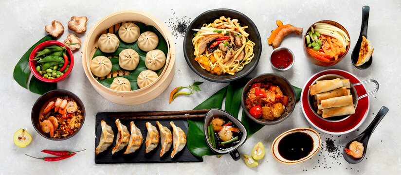 Assorted Chinese food on dark background. Asian food concept. Top view.
