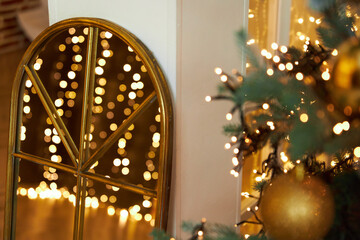 Fototapeta premium blurry lights of garland are reflected in mirror. Christmas and New Year background