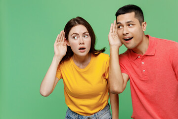 Young curious nosy couple two friends family man woman wear basic t-shirts together try to hear you...