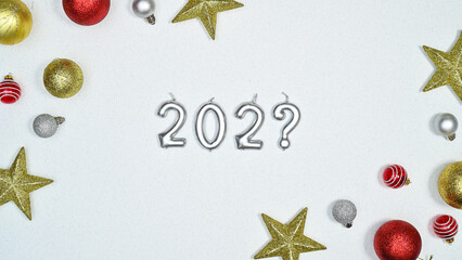 Creative Chrsitmas and new year background with 202? numbers and shiny ornamnets on white background. Flat lay