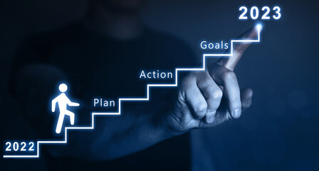 New Year 2023 with plan, action and goals.Businessman pointing to the growing plan of successful...