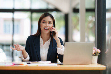 Asian Business woman making business call talking on phone. Account and Finance concept